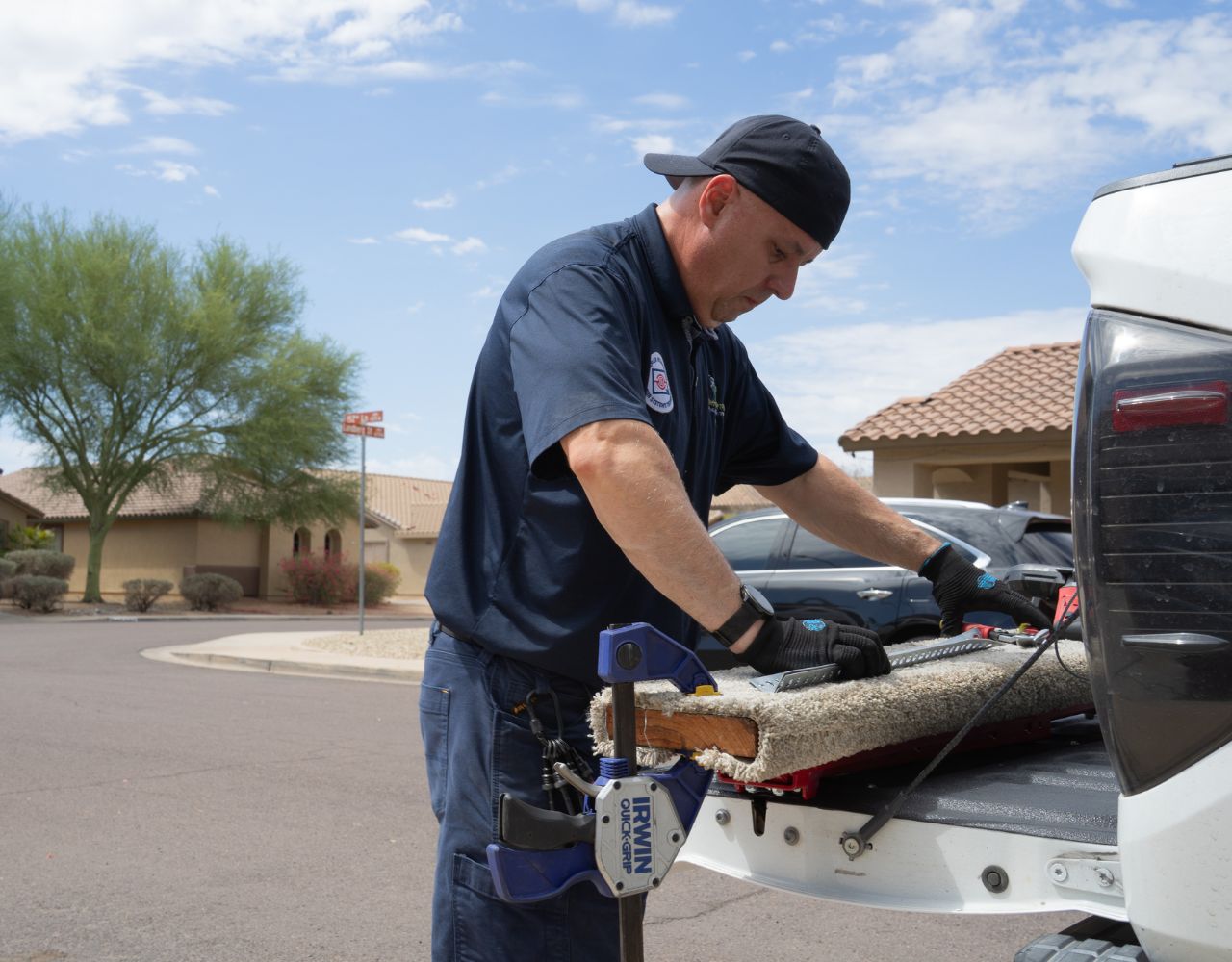 Garage door technician preparing tools for residential garage door service
